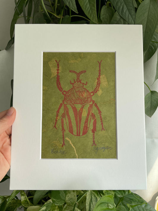 Red Beetle on handmade green leaf paper matted to 8x10"